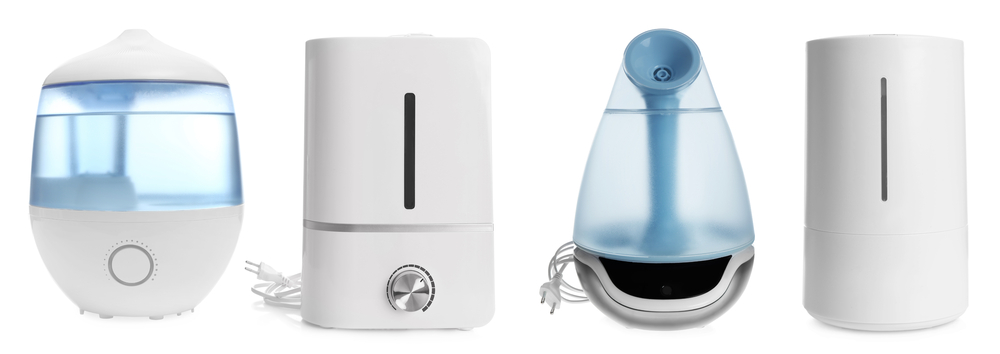 Set of modern air humidifiers on white background